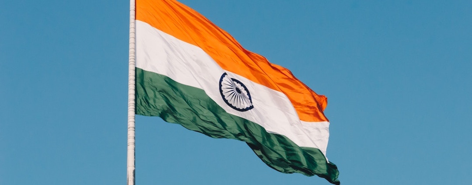 The Indian flag against a blue sky